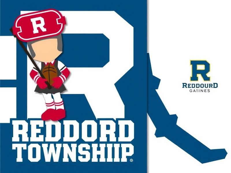 A scenic view of farm fields and a small town, representing both the game and real-world township